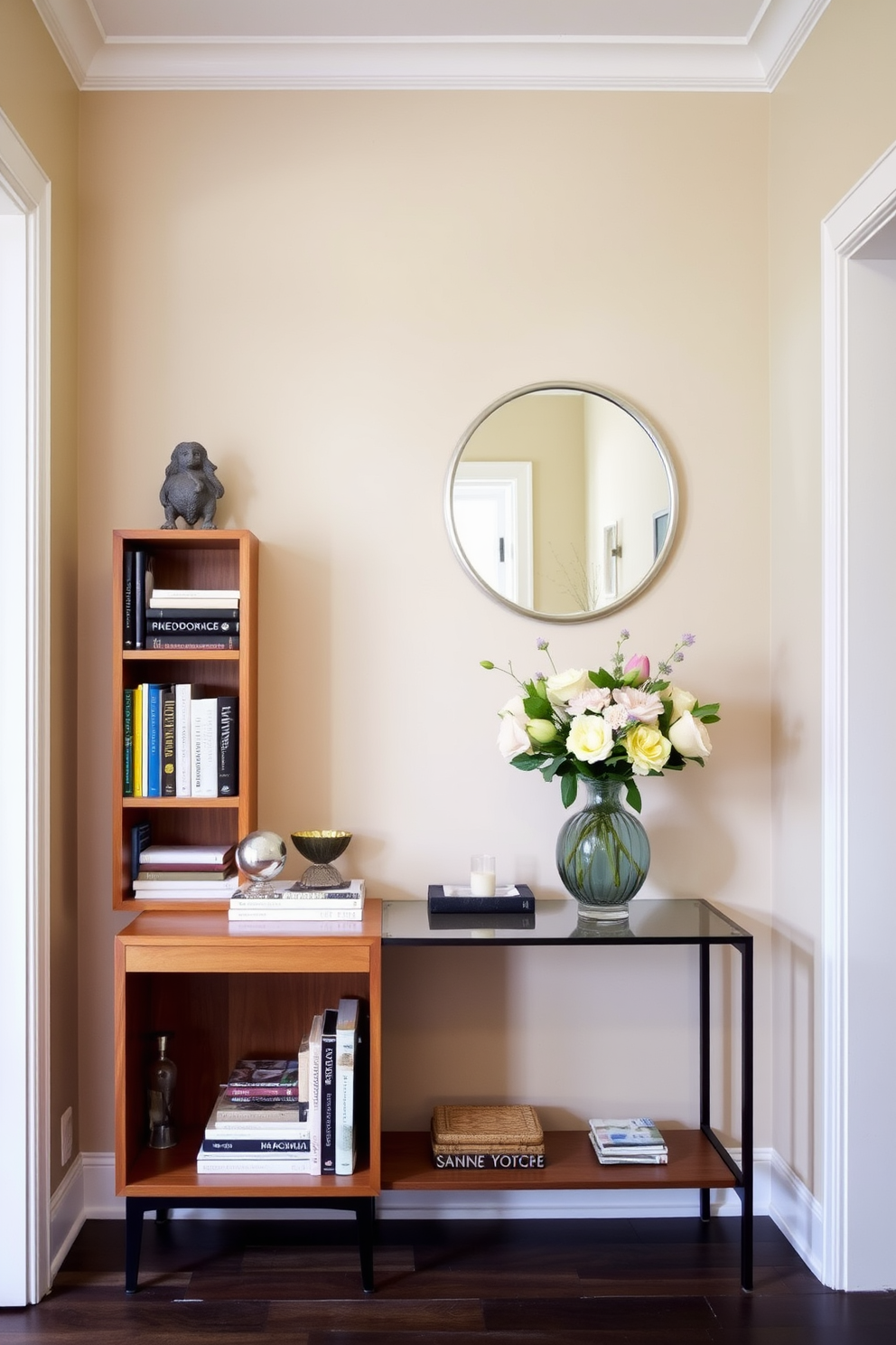 A charming entryway features a small wooden bookshelf with a warm finish, filled with an assortment of books and decorative items. The walls are painted in a soft beige, complemented by a stylish console table adorned with a vase of fresh flowers and a round mirror above it.