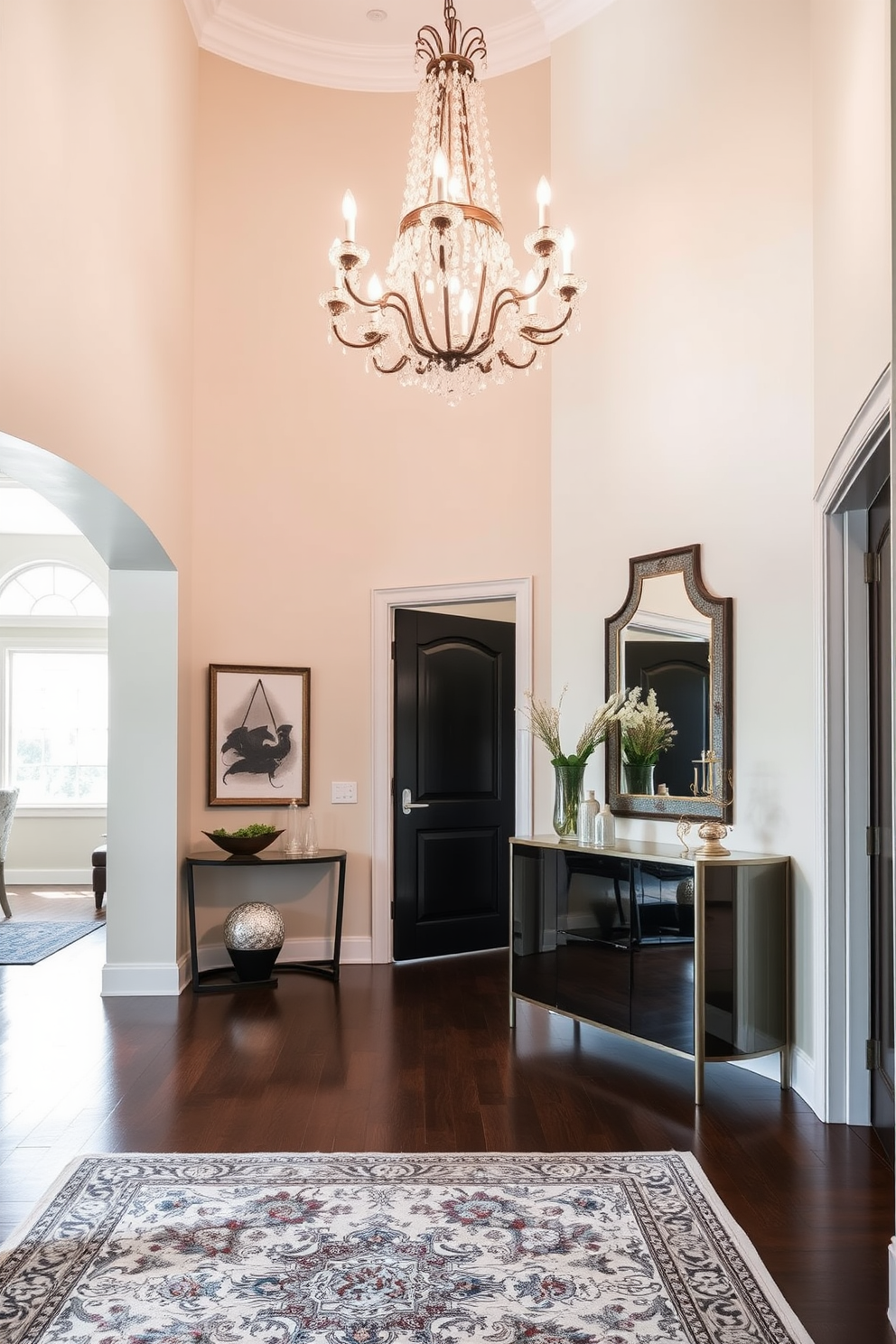 A stunning entryway that welcomes guests with elegance and style. The space features a grand chandelier hanging from a high ceiling, casting a warm glow over the polished wooden floor. On one side, a sleek console table is adorned with decorative items and a stylish mirror above it. The walls are painted in a soft neutral tone, complemented by an intricate area rug that adds a touch of color and texture.