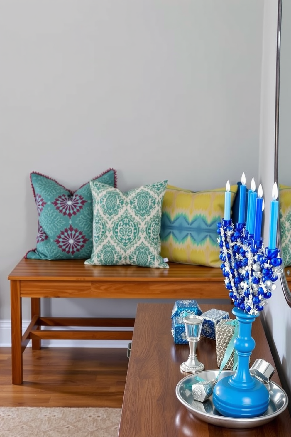 Seasonal throw pillows in vibrant colors and patterns are arranged on a cozy wooden bench. The bench is positioned against a light gray wall, creating an inviting focal point in the entryway. For Hanukkah decorating ideas, a beautifully decorated menorah is placed on a console table. Surrounding the menorah are festive blue and silver accents, including decorative candles and a collection of dreidels.