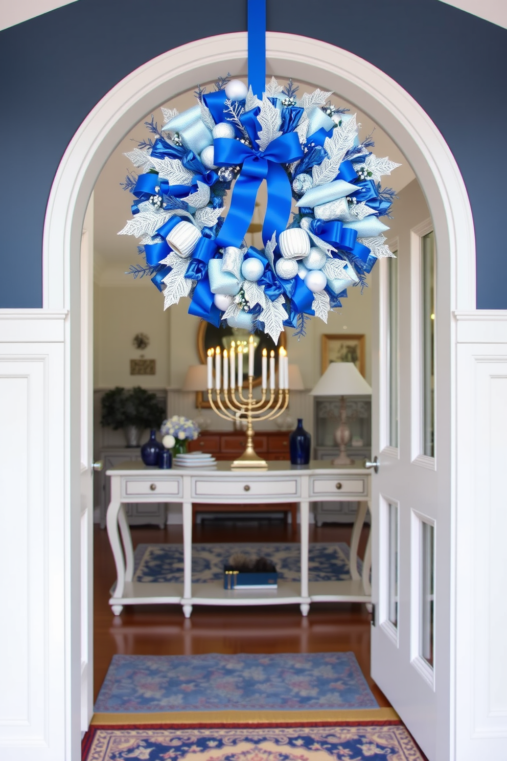 A blue and silver wreath adorns the front door, creating a festive and inviting entryway. Inside, the space is decorated with elegant Hanukkah elements, including a menorah on a console table and blue and silver accents throughout.