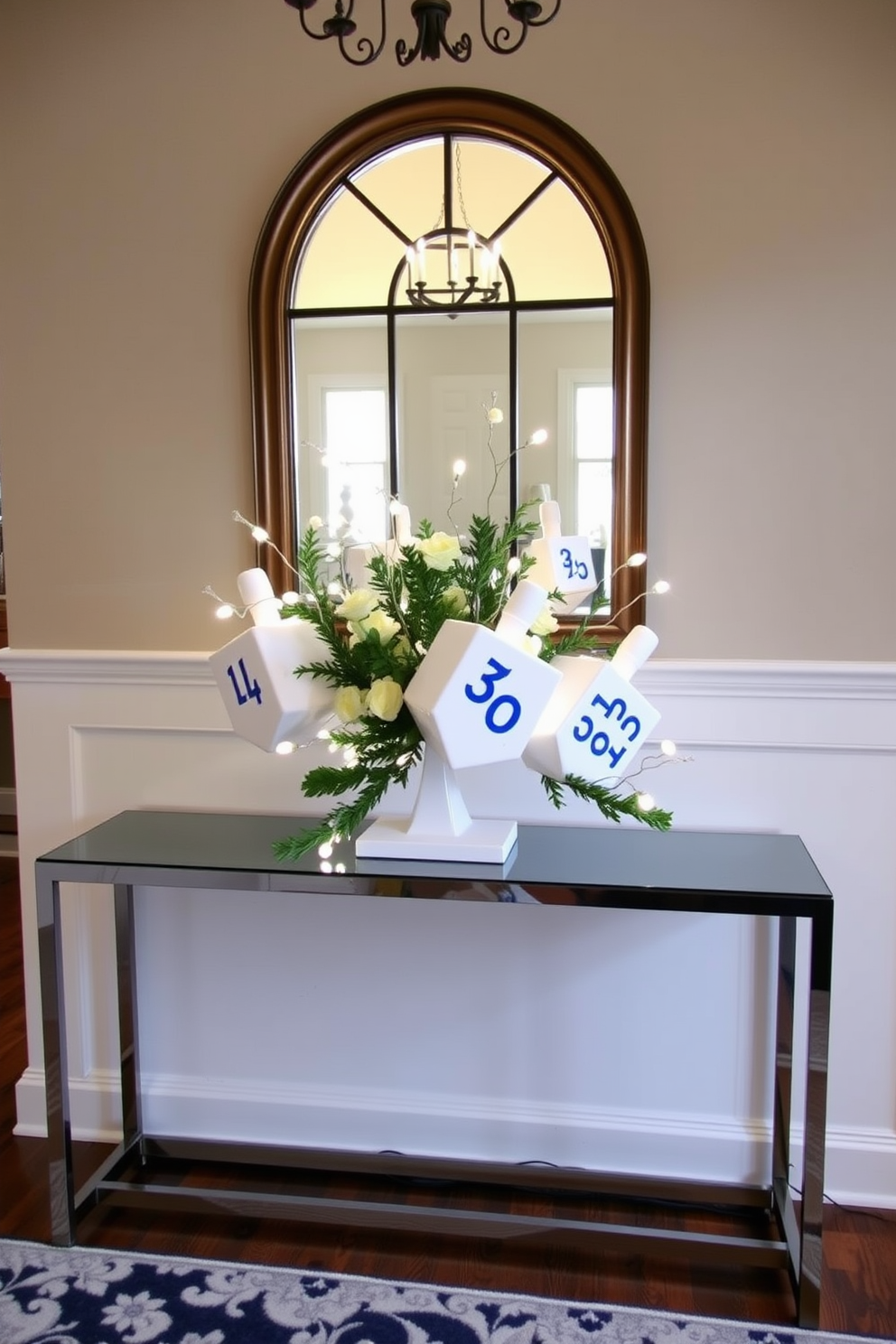 A beautiful entryway features a decorative dreidel centerpiece placed on a sleek console table. The dreidels are arranged in an artistic manner with soft white lights and greenery, creating a warm and inviting atmosphere for Hanukkah celebrations.