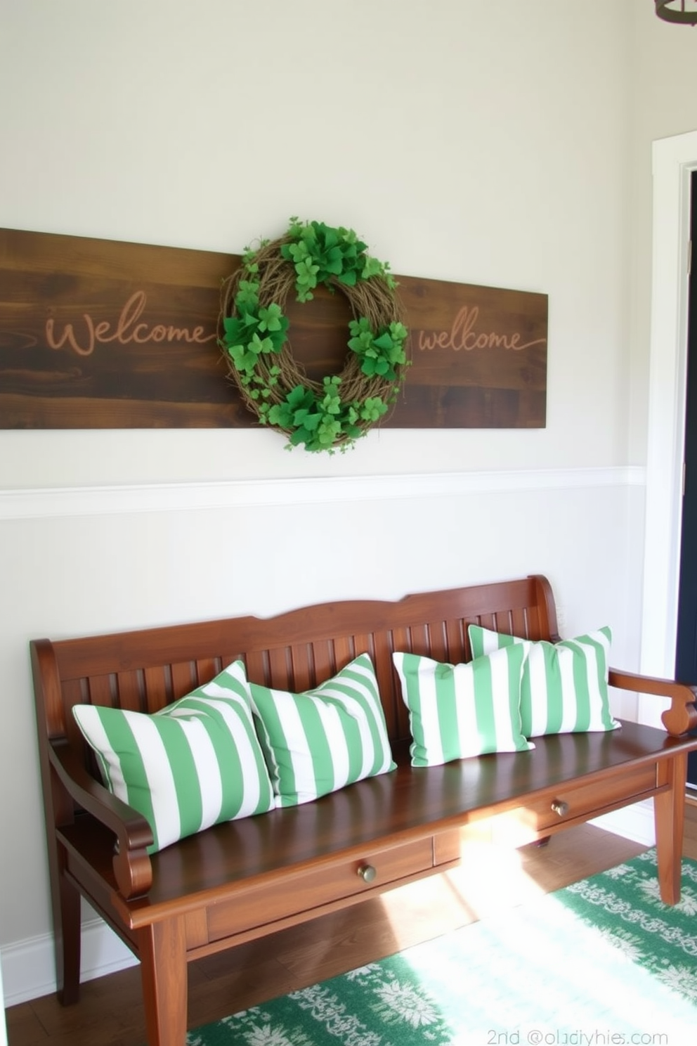 A welcoming entryway features a long wooden bench adorned with green and white striped pillows. Above the bench, a decorative wreath with shamrocks adds a festive touch for St. Patrick's Day.