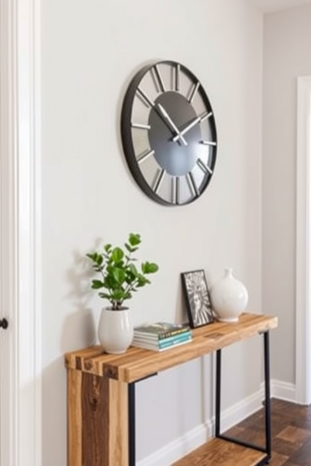 A chic clock serves as a functional accent in a stylish entryway. The clock features a sleek design with a minimalist face and is mounted above a modern console table. The entryway table is crafted from reclaimed wood, showcasing its natural grain. Decorative items such as a small potted plant and a stack of art books are elegantly arranged on the table.