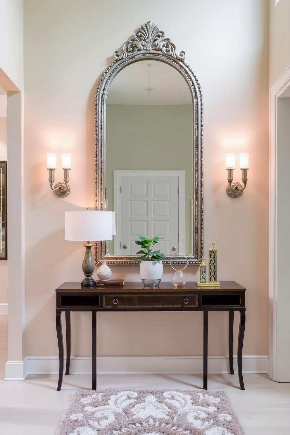 A stunning entryway featuring a statement mirror with an ornate decorative frame. The walls are adorned with a soft, welcoming hue and accented with elegant wall sconces to enhance the ambiance. The entryway showcases a stylish console table beneath the mirror, topped with decorative items and a small potted plant. A plush runner rug adds warmth and texture, guiding guests into the home.