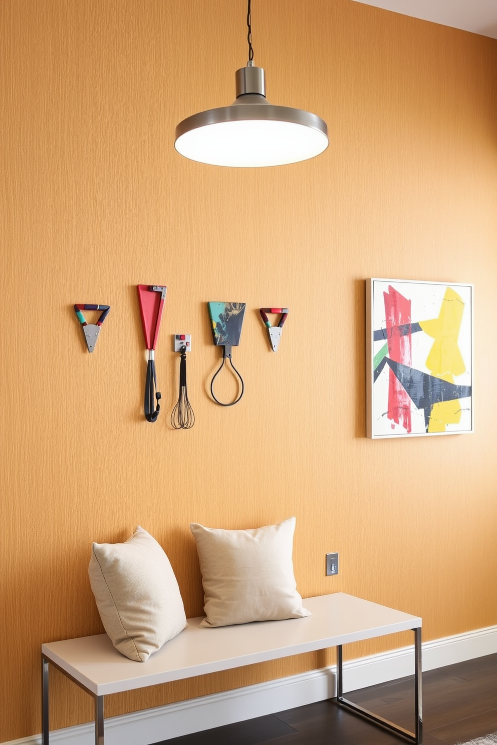 Coat hooks with artistic flair hang on a feature wall adorned with textured wallpaper in a warm neutral tone. Below the hooks, a sleek bench with plush cushions invites guests to sit and remove their shoes, creating a welcoming atmosphere. The entryway is illuminated by a modern pendant light that casts a soft glow, enhancing the artistic elements of the coat hooks. A vibrant piece of abstract art is mounted on the opposite wall, adding a splash of color and personality to the space.