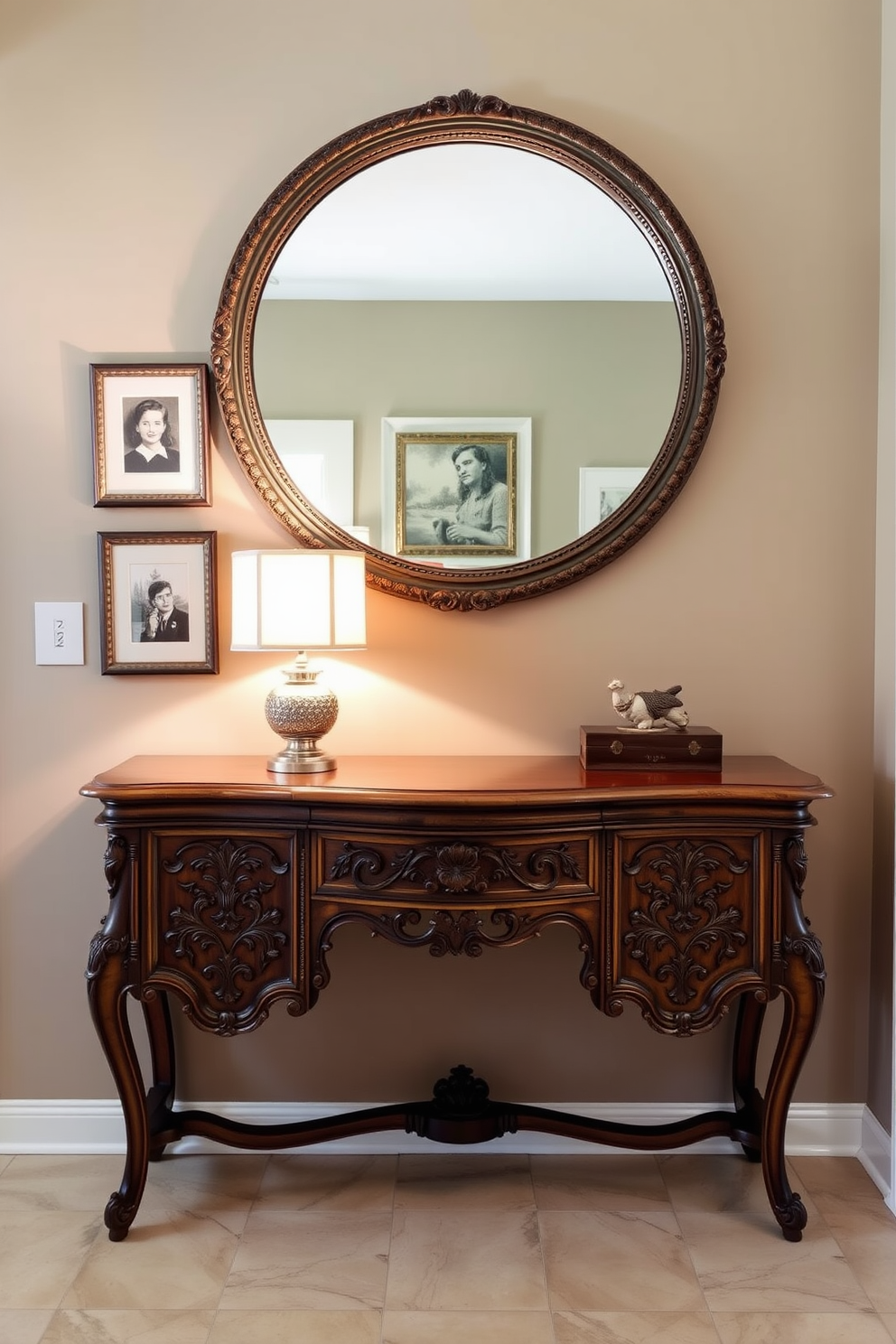 A vintage console table with intricate carvings is positioned against the wall in the entryway, providing both style and functionality. Above the table, a large round mirror with an ornate frame reflects natural light, enhancing the space's warmth and charm. The wall behind the console table is painted in a soft taupe hue, complemented by framed artwork that adds personality. A stylish table lamp sits on the console, casting a warm glow and inviting guests into the home.