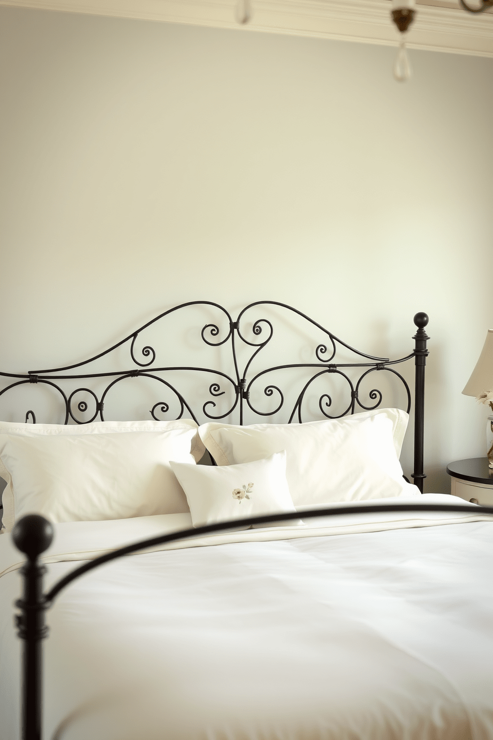 Elegant wrought iron bed with soft linens. The room features a soothing color palette with pastel hues and delicate floral accents.