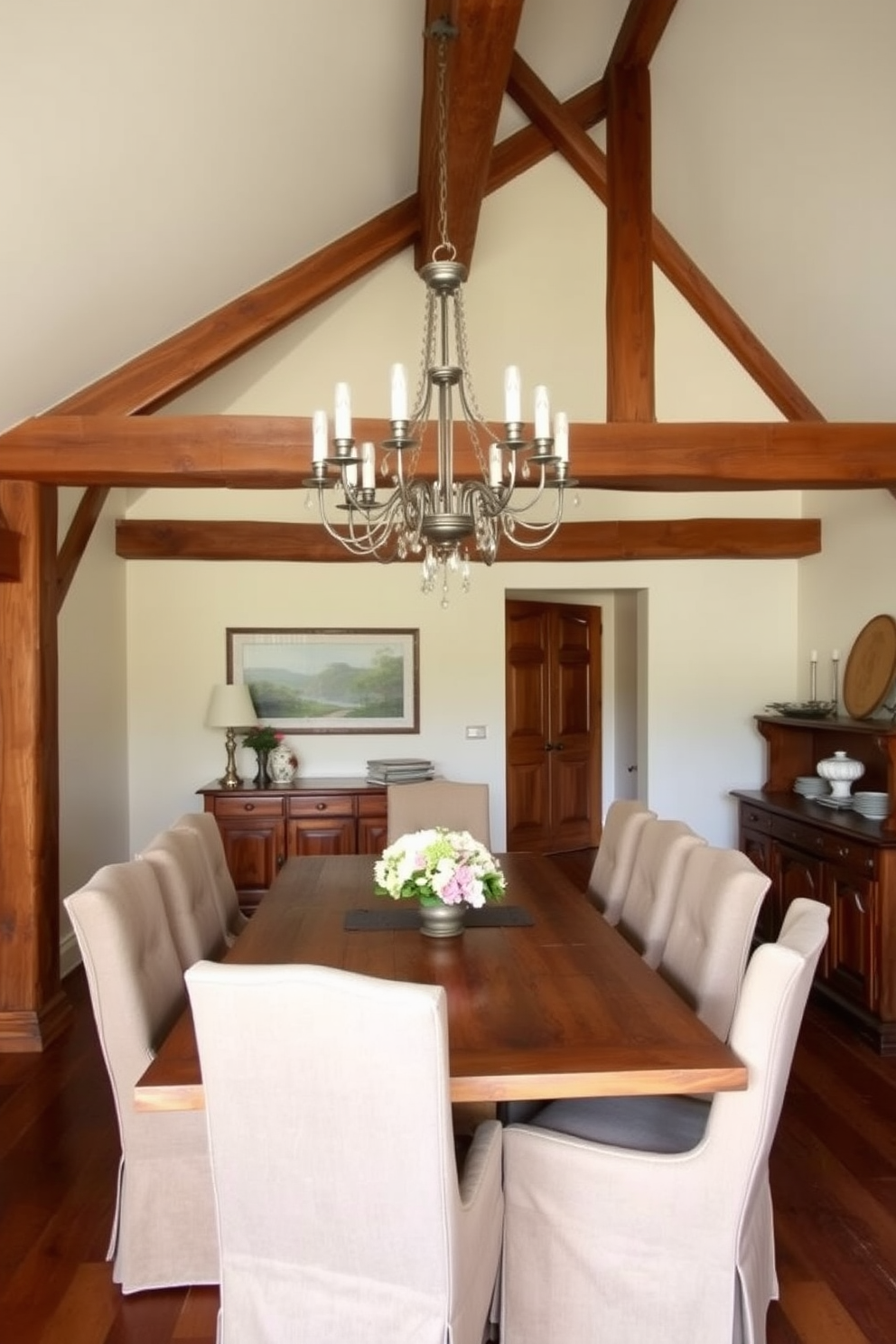 A traditional European dining room features exposed wooden beams that add warmth and character to the space. The table is made of reclaimed wood and surrounded by upholstered chairs, creating an inviting atmosphere for family gatherings. On the walls, soft cream paint complements the rich tones of the wood, while a large chandelier hangs above the table, providing an elegant focal point. A sideboard displays fine china and decorative pieces, enhancing the room's rustic charm.