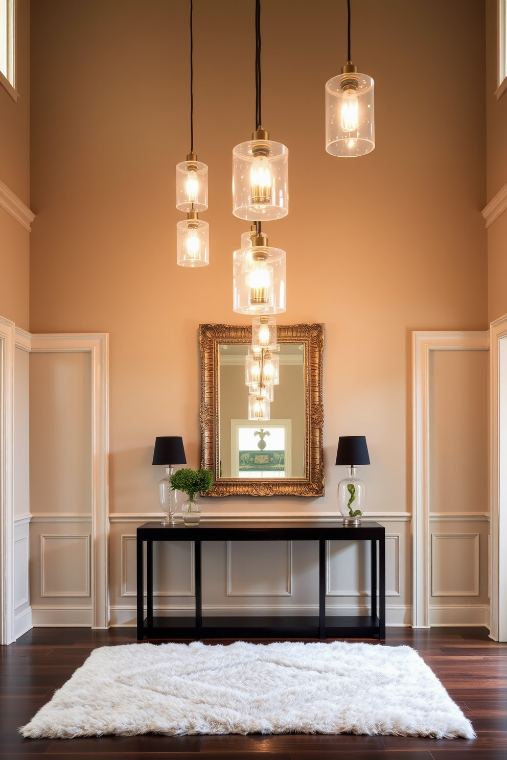 A stunning foyer featuring stylish pendant lights that hang gracefully from a high ceiling. The walls are adorned with elegant wainscoting, and a plush area rug lays beneath a sleek console table. The pendant lights are crafted from glass and metal, casting a warm glow throughout the space. A large mirror with an ornate frame reflects the light and enhances the foyer's sense of depth and sophistication.