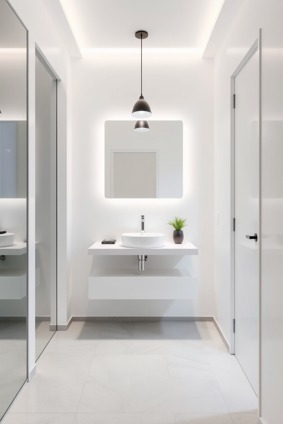 A minimalistic powder room features sleek white walls and a floating vanity with a single basin. The space is accented by a large frameless mirror and subtle pendant lighting that enhances the clean lines and simplicity of the design. The floor is adorned with light gray tiles that create a seamless look, while a small potted plant adds a touch of greenery. The overall aesthetic is calm and uncluttered, embodying the essence of European minimalism.