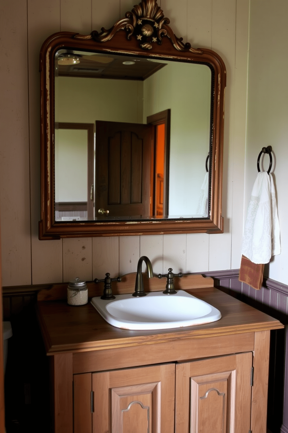 Antique mirror with a distressed frame hangs above a rustic wooden vanity. The vanity features a farmhouse sink and is complemented by vintage brass fixtures in a cozy bathroom setting.