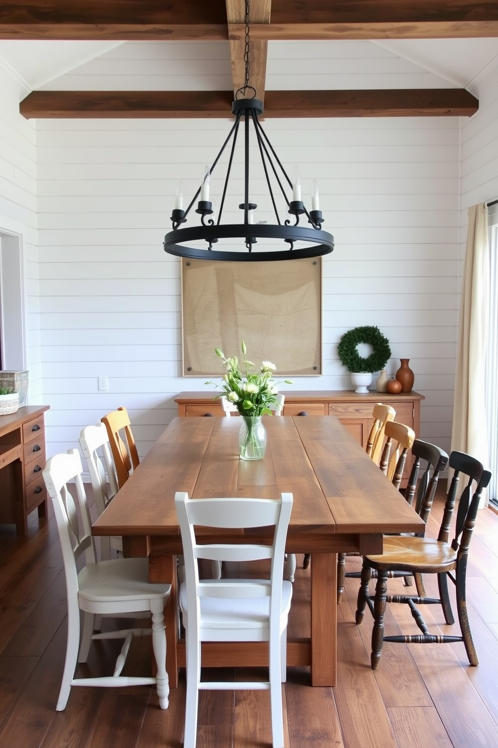 A charming farmhouse dining room features reclaimed wood accents that add warmth and character to the space. A large farmhouse table made of distressed wood is surrounded by mismatched chairs, creating an inviting and casual atmosphere. The walls are adorned with shiplap in a soft white finish, enhancing the rustic vibe. A statement light fixture made of wrought iron hangs above the table, casting a warm glow during intimate dinners.