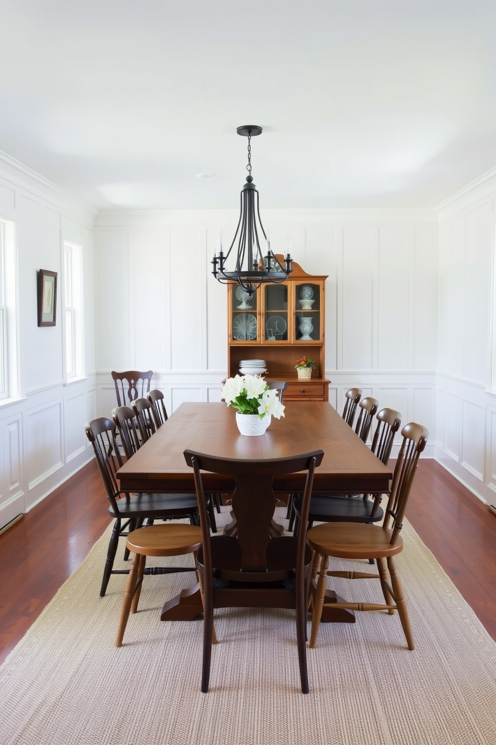 A charming farmhouse dining room featuring classic white wainscoting that adds a touch of elegance. The room includes a large wooden dining table surrounded by mismatched chairs, with a rustic chandelier hanging above.