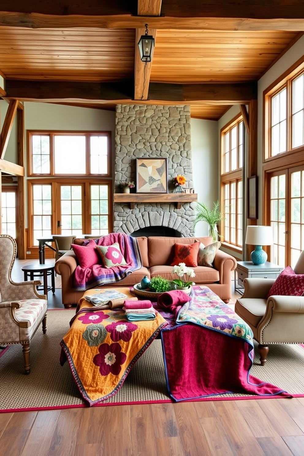 A cozy farmhouse living room featuring colorful quilts draped over a large, comfortable sofa. The room is accented with rustic wooden beams and a stone fireplace, creating a warm and inviting atmosphere. Brightly colored quilts are layered on a vintage coffee table, surrounded by mismatched armchairs. Large windows allow natural light to flood the space, highlighting the earthy tones of the decor.