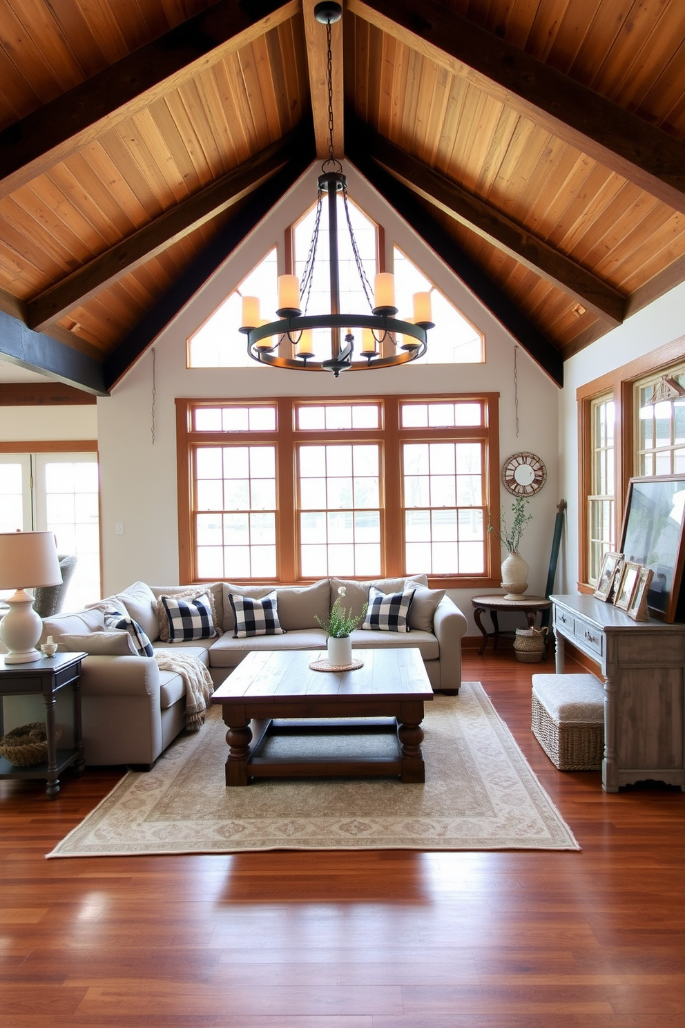 A cozy farmhouse living room with a wooden beam ceiling and large windows allowing natural light to flood the space. A stunning farmhouse-style chandelier hangs from the ceiling, providing warm ambiance and enhancing the rustic charm of the room. The room features a comfortable sectional sofa adorned with plaid throw pillows and a reclaimed wood coffee table at the center. Soft area rugs in neutral tones cover the hardwood floor, while vintage decor elements, such as a distressed side table and framed family photos, add character to the space.