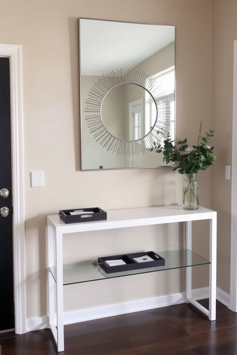 A welcoming foyer space features a sleek console table against the wall adorned with decorative trays for keys and mail. The walls are painted in a soft beige hue, complemented by a stylish mirror above the table that reflects natural light.