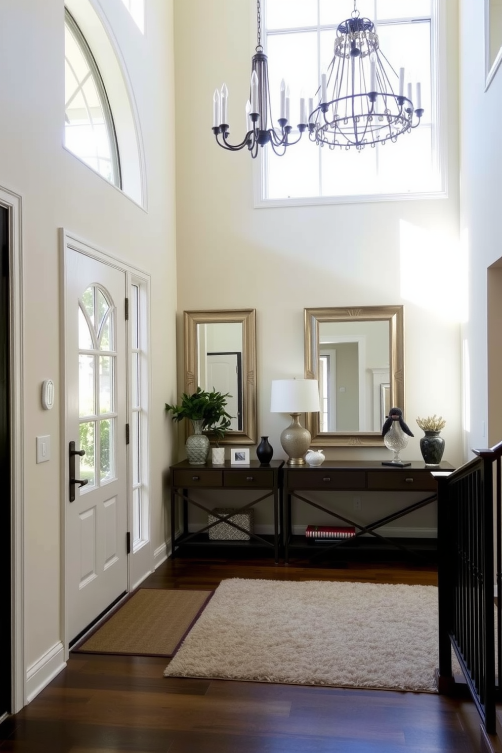 A bright and inviting foyer with large windows that allow ample natural light to fill the space. The walls are painted in a soft cream color, and a stylish console table with decorative items sits against one wall. A pair of elegant mirrors are strategically placed to reflect light and create a sense of depth. A plush area rug in neutral tones anchors the space, while a statement chandelier adds a touch of luxury overhead.