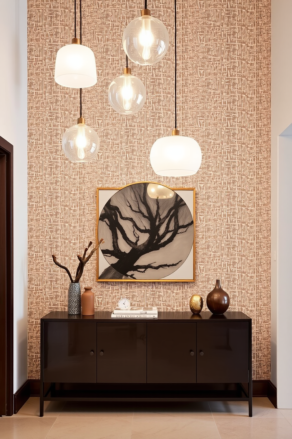 A modern foyer entryway showcases hanging pendant lights that create an inviting atmosphere. The space features a sleek console table against a backdrop of textured wallpaper, with decorative elements that enhance the contemporary style.