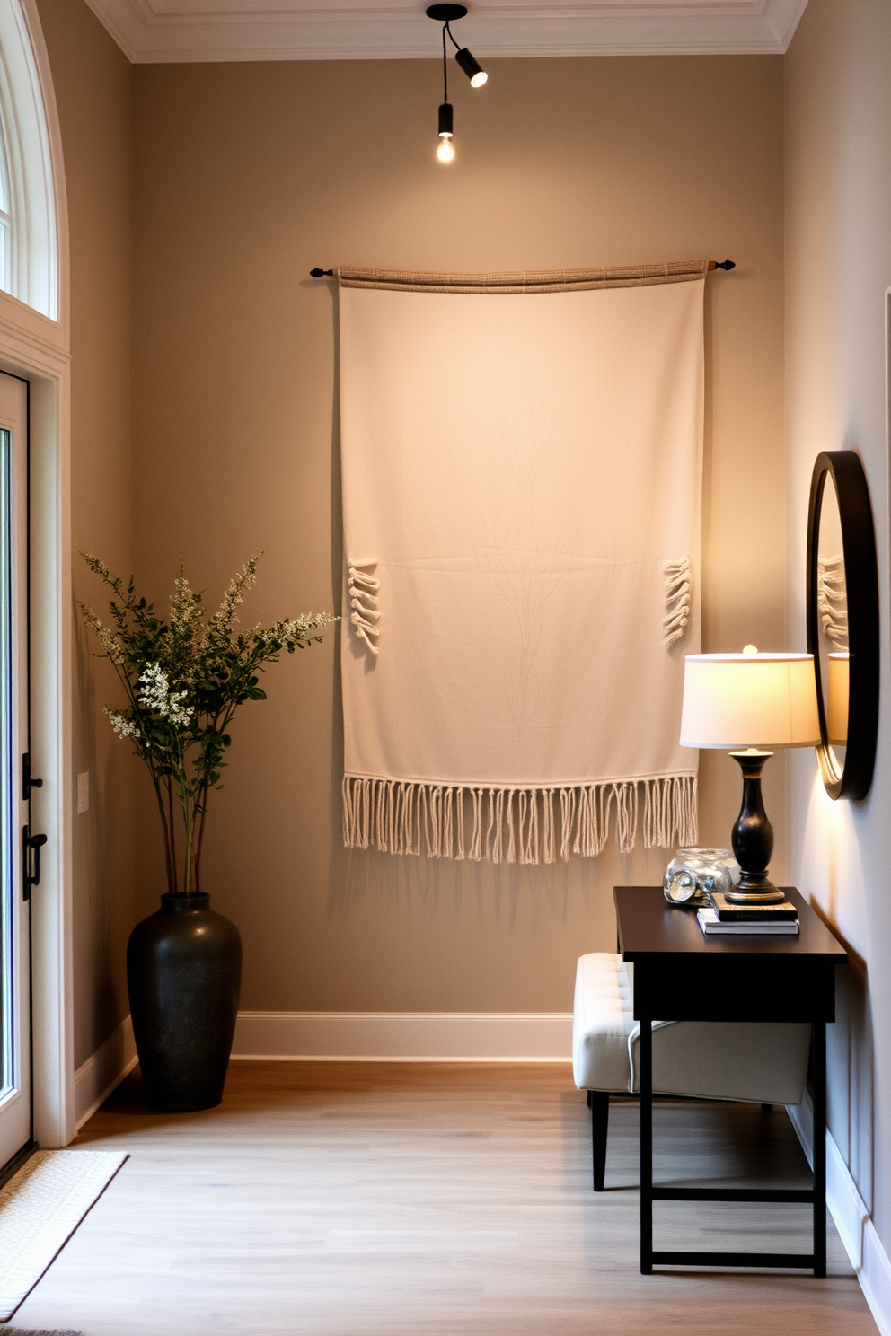 A welcoming foyer featuring soft fabric wall hangings that add warmth and texture to the space. The walls are adorned with a mix of neutral tones and subtle patterns, creating an inviting atmosphere.