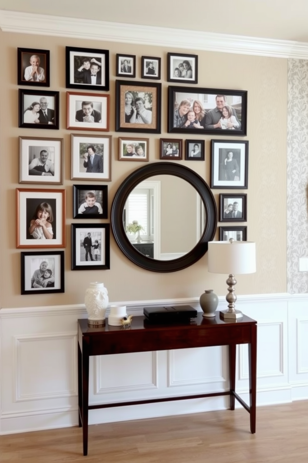 A gallery wall filled with framed family photos in various sizes creates a warm and inviting atmosphere. The frames are arranged in a cohesive yet eclectic style, showcasing cherished memories against a soft beige wall. For the foyer, a stunning wall design features a combination of textured wallpaper and elegant wainscoting. A large round mirror hangs above a sleek console table, complemented by decorative accessories and a stylish lamp.