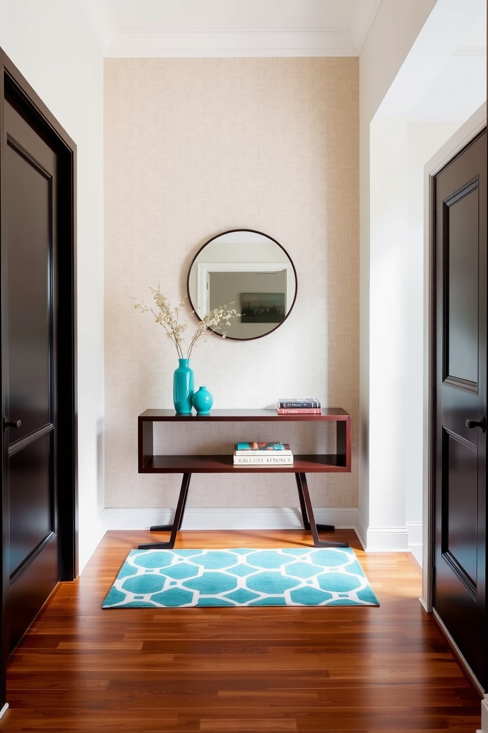 A welcoming foyer featuring a statement wall adorned with textured wallpaper in soft beige. The furniture includes a sleek console table in dark wood, accented with vibrant teal decor pieces and a round mirror above it. The floor is finished with polished hardwood, providing a warm contrast to the light walls. A stylish rug in geometric patterns adds a pop of color, harmonizing with the accent colors of the decor.