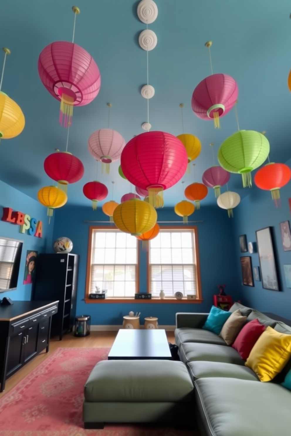 A vibrant game room adorned with colorful paper lanterns hanging from the ceiling. The walls are painted in a playful blue shade, and a large, cozy sectional sofa invites relaxation and fun.