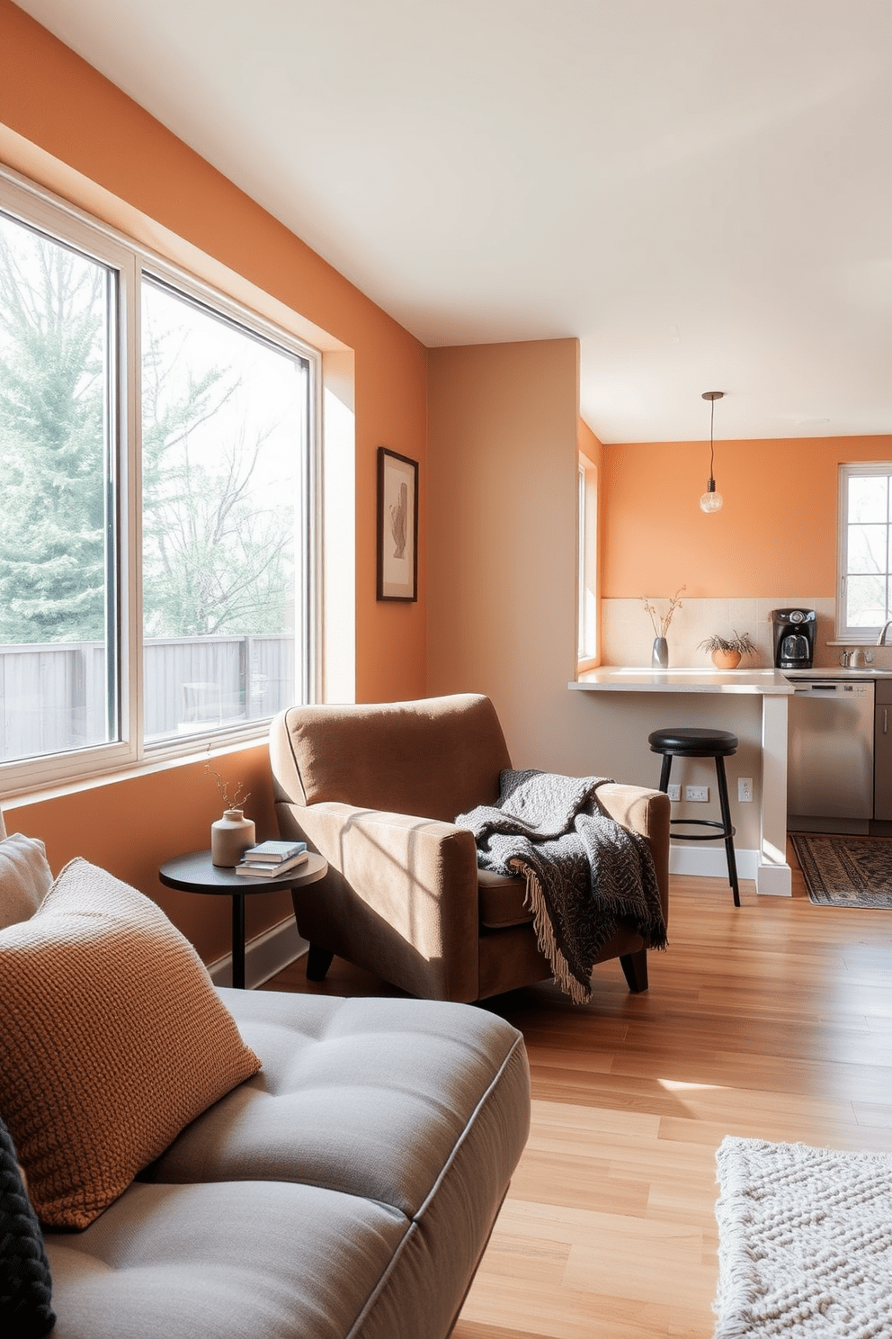 Cozy reading nook with natural light. A plush armchair is positioned by a large window, inviting sunlight to fill the space. Soft throw blankets and a stack of books rest on a small side table. The walls are adorned with warm, neutral tones, creating a serene atmosphere. Garage apartment design ideas. The open layout features a modern kitchenette seamlessly integrated with a living area. Large windows provide ample natural light, while a minimalist decor style emphasizes functionality and comfort.