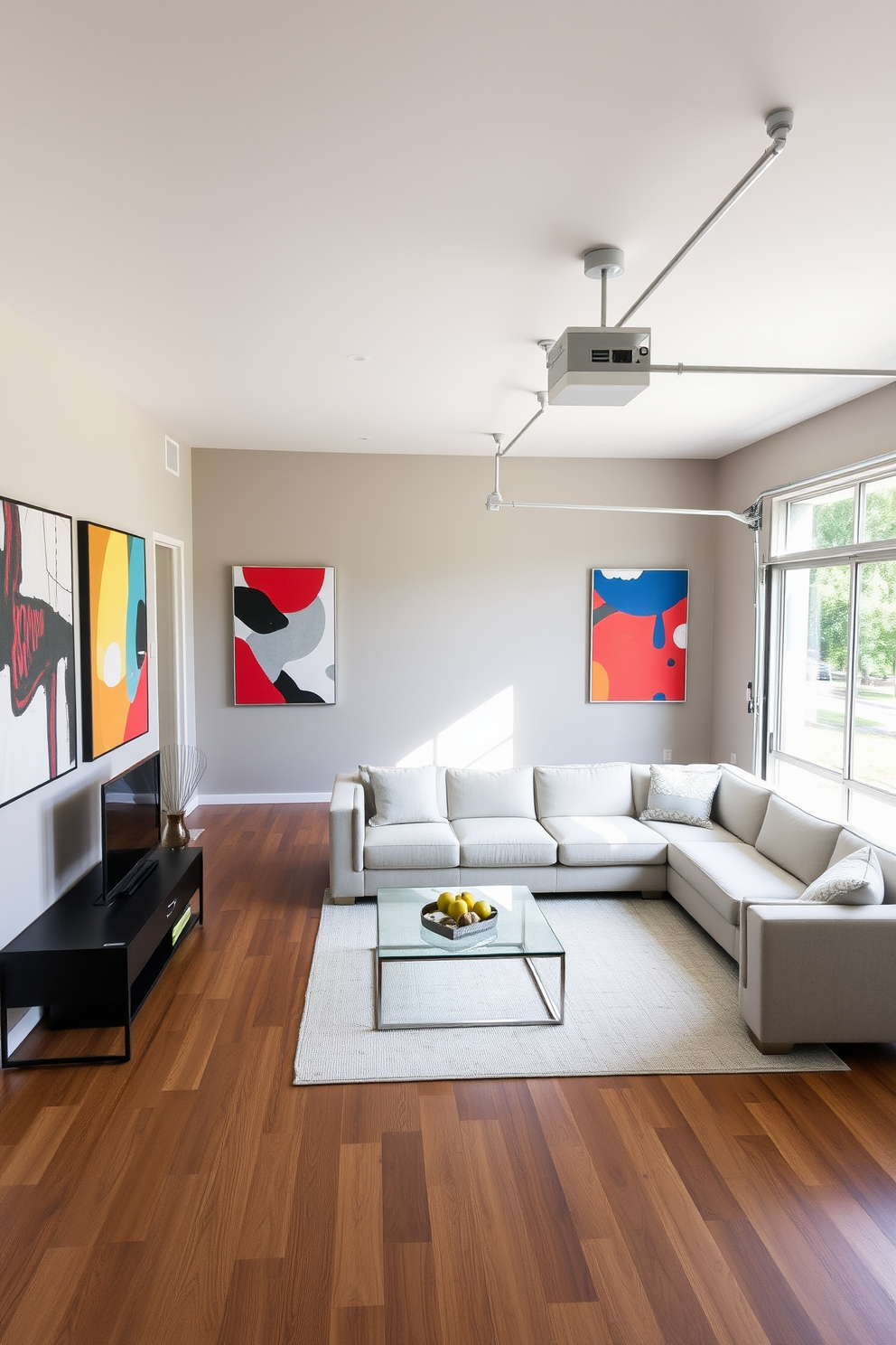 A spacious garage transformed into a stylish living space featuring modern wall art that adds contemporary flair. The walls are adorned with abstract paintings in bold colors, creating a vibrant contrast against the neutral tones of the room. The living area includes a sleek sectional sofa in a light fabric, complemented by a glass coffee table. Large windows allow natural light to flood the space, enhancing the warmth of the wooden flooring.