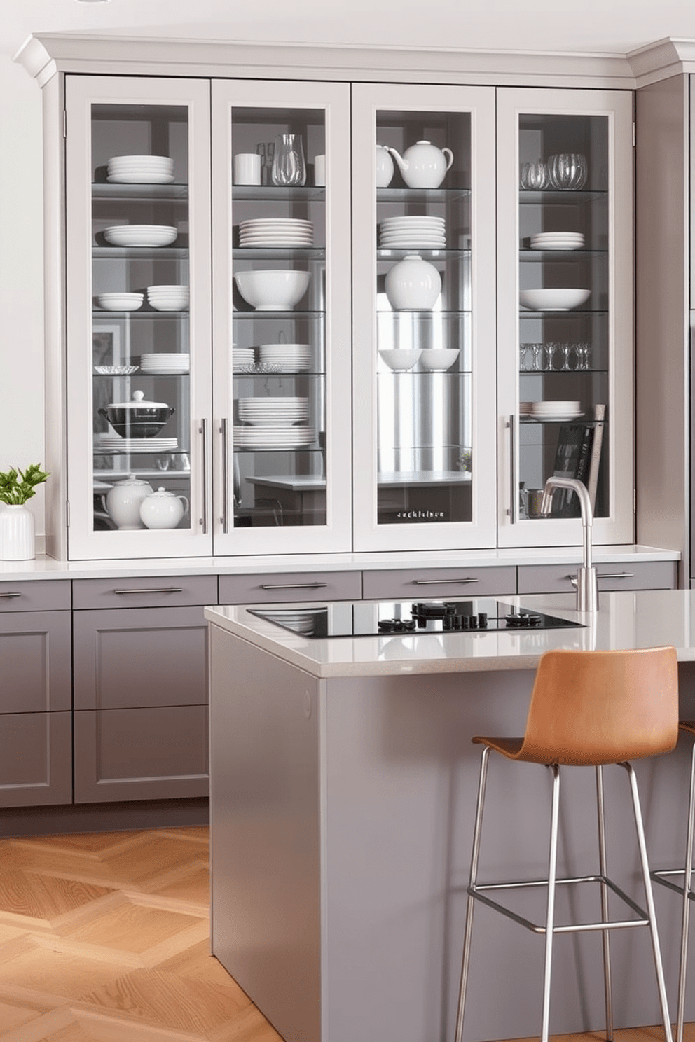 A modern German kitchen featuring sleek glass-front cabinets that showcase elegant dishware and decorative items. The cabinetry is complemented by a minimalist island with a built-in cooktop and stylish bar stools for casual dining.