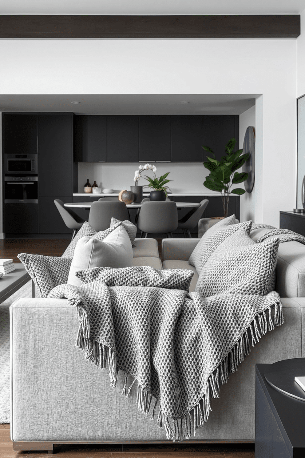 A modern gray apartment featuring textured gray throw blankets draped over stylish sofas. The space is accentuated with sleek furniture and minimalist decor, creating a cozy yet sophisticated atmosphere.