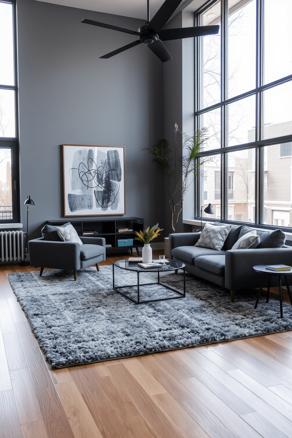 A stylish gray apartment featuring layered gray rugs that add depth and texture to the living space. The walls are adorned with contemporary art, and large windows allow natural light to flood the room, enhancing the cozy atmosphere.