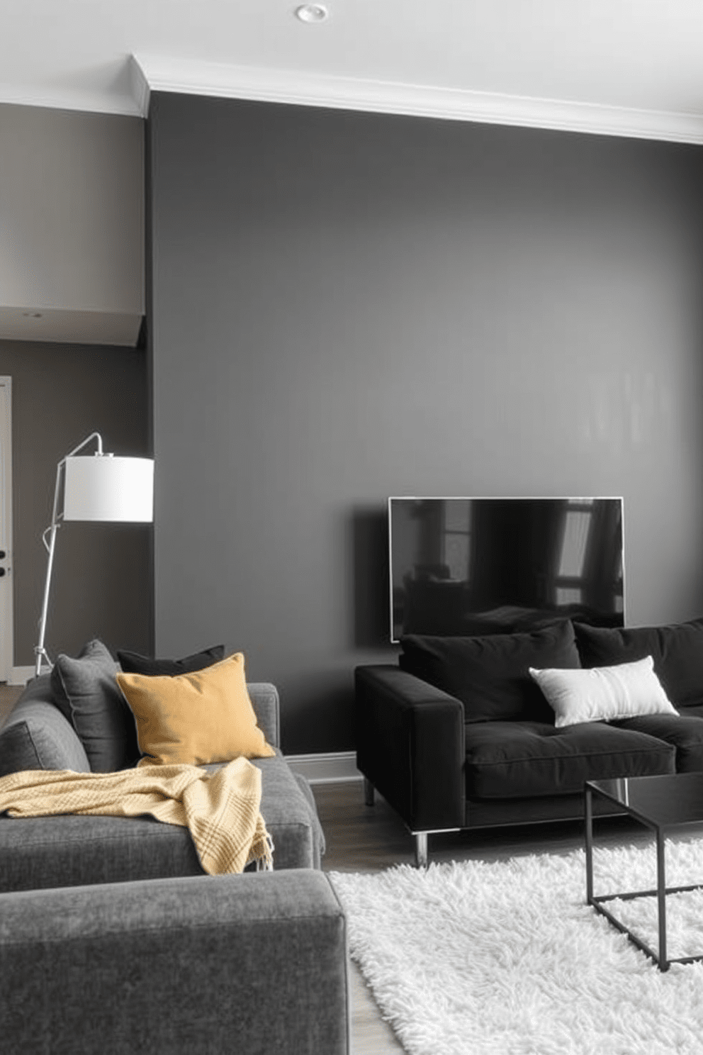 An accent wall painted in dark gray creates a striking focal point in the living space. The surrounding walls are a soft white, enhancing the modern aesthetic of the gray apartment design. Incorporate sleek furniture with clean lines in shades of gray and black to complement the accent wall. A plush area rug in a lighter tone adds warmth and texture to the overall design.