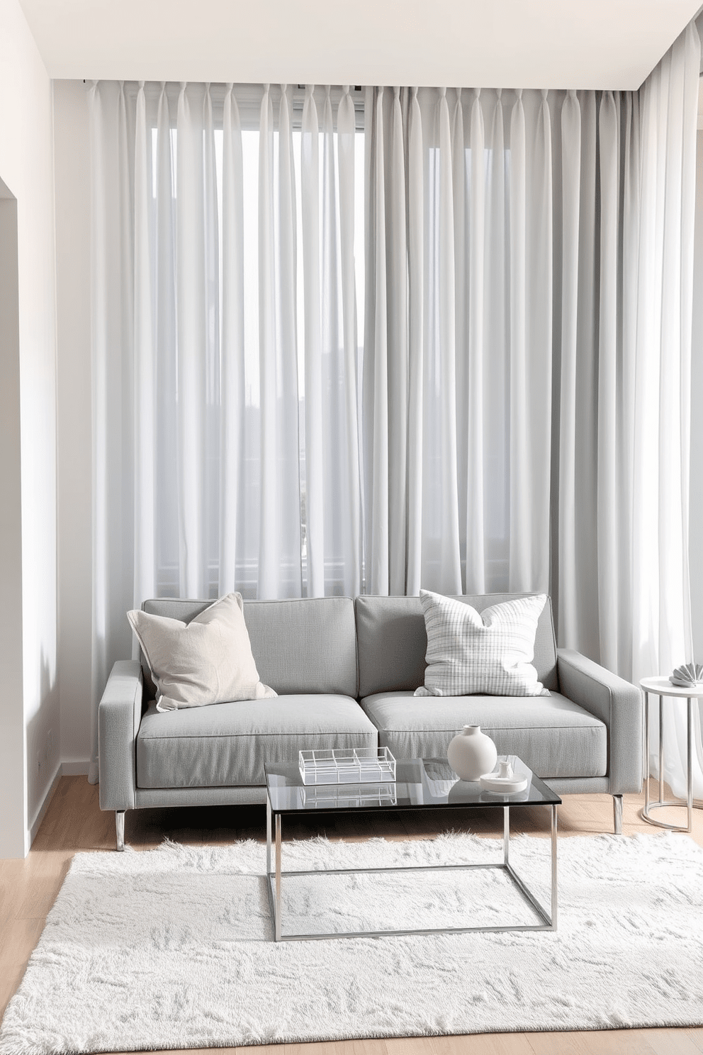 A modern apartment interior featuring light gray curtains that enhance the airy atmosphere. The space includes minimalist furniture with sleek lines and a neutral color palette to create a serene environment. The living area showcases a comfortable gray sofa paired with a glass coffee table and a soft area rug. Accent pillows in various textures add depth and interest to the seating arrangement while maintaining a cohesive look.