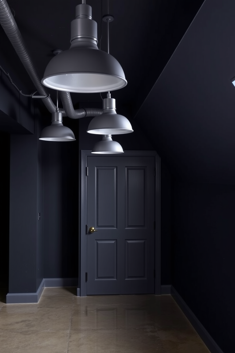 A contemporary basement design featuring industrial gray lighting fixtures that hang from the ceiling. The walls are painted in a deep charcoal color, and the floor is polished concrete, creating a sleek and modern atmosphere.