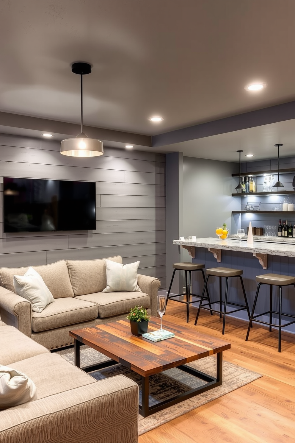 Accent wall with gray shiplap panels. The basement features a cozy seating area with a plush sectional sofa and a rustic coffee table, illuminated by soft pendant lighting. Incorporate a stylish bar area with high stools and modern shelving for drinks. The flooring is a warm wood tone that complements the gray walls, creating an inviting atmosphere.