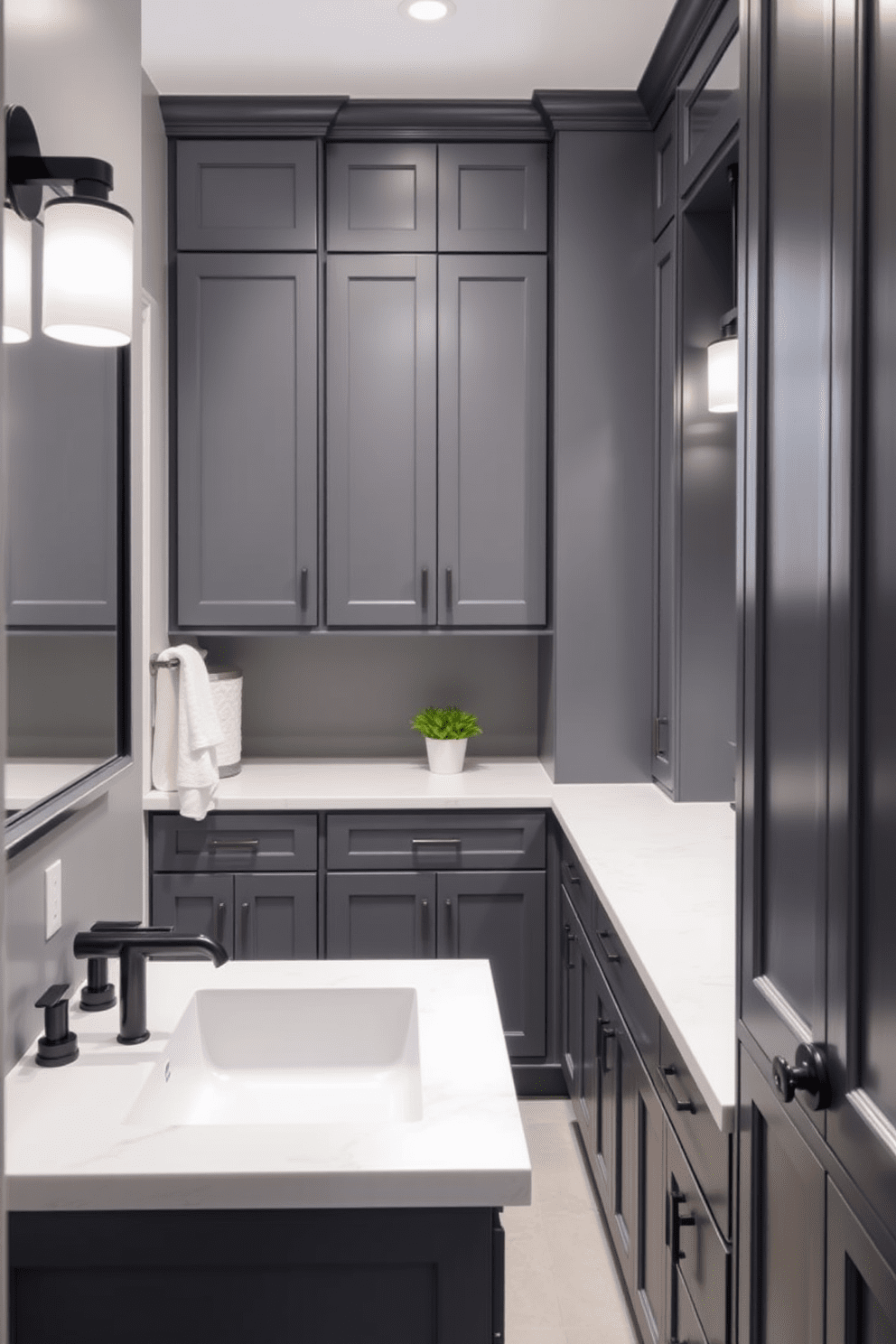 A modern gray bathroom featuring dark gray cabinets paired with sleek light countertops. The space is accentuated by stylish fixtures and a minimalist aesthetic, creating a serene atmosphere.