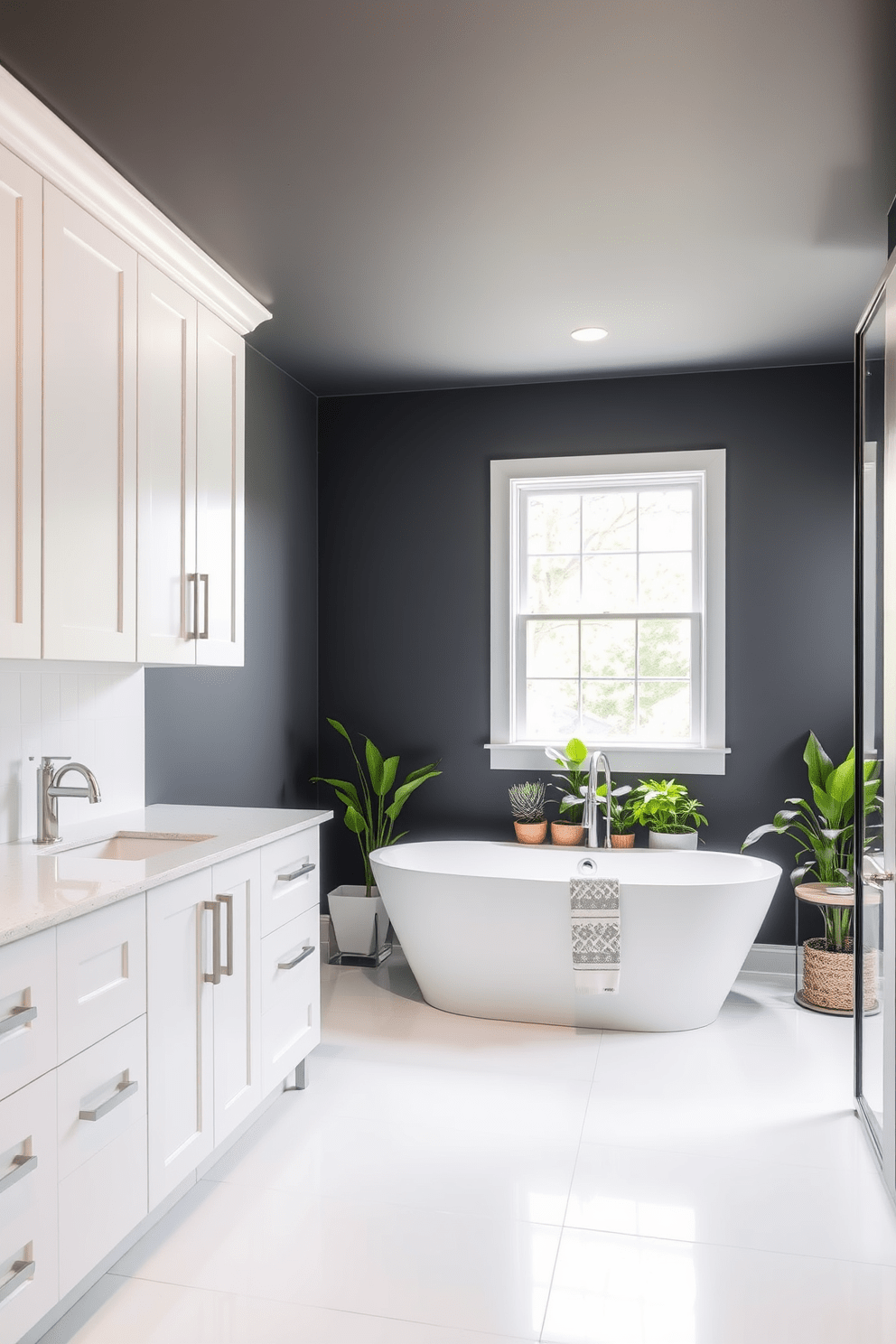 Accent wall in deep slate gray. The bathroom features sleek white cabinetry paired with brushed nickel fixtures. A freestanding soaking tub sits under a large window, surrounded by potted plants for a touch of nature. The floor is covered with large format white tiles that contrast beautifully with the dark wall.