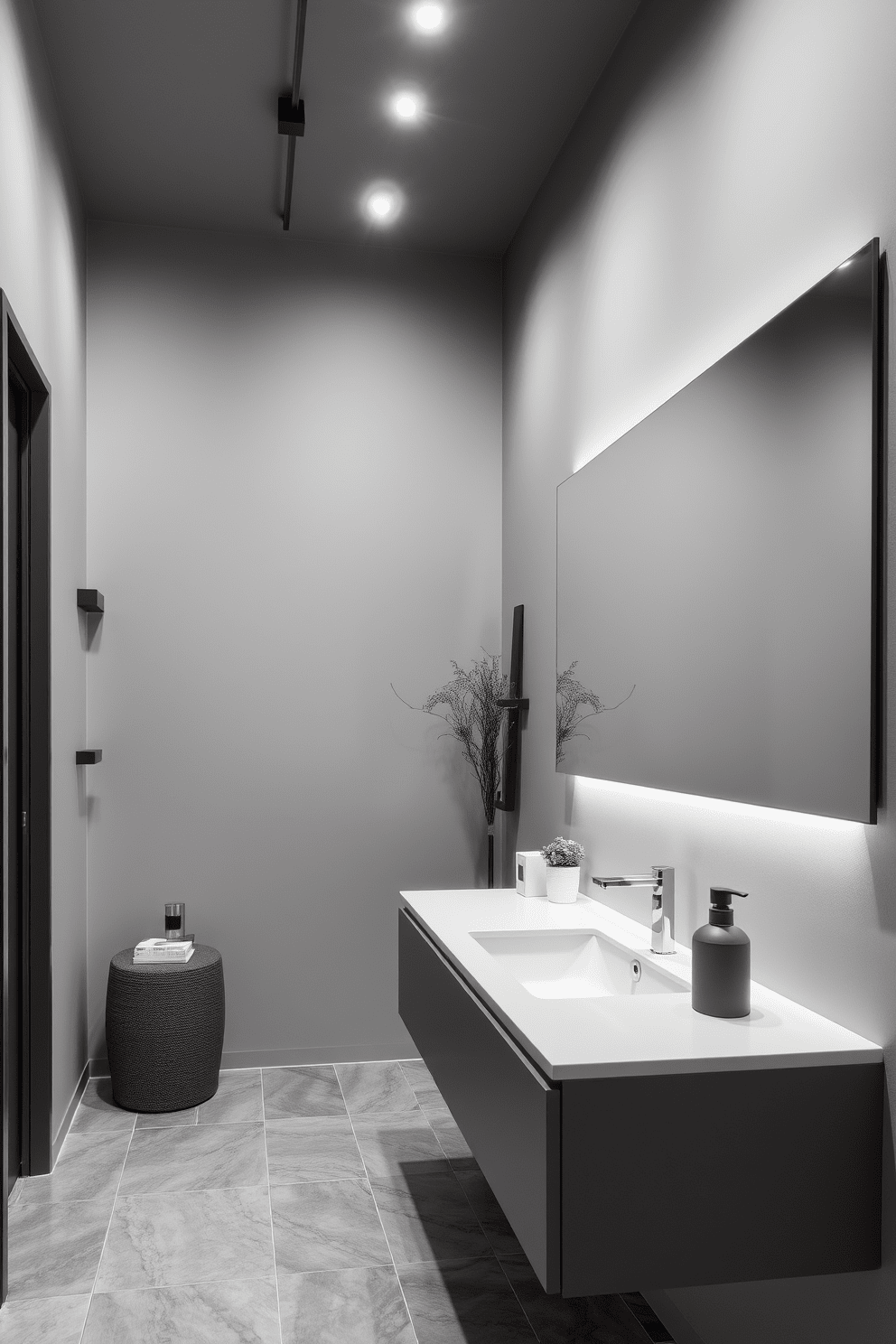 A contemporary gray bathroom setting features sleek gray lighting fixtures that elegantly illuminate the space. The walls are adorned with a soft gray hue, complemented by modern accents and stylish decor elements. The bathroom showcases a minimalist design with a floating vanity and a large mirror that enhances the room's openness. Gray tiles line the floor, creating a cohesive and sophisticated look throughout the space.