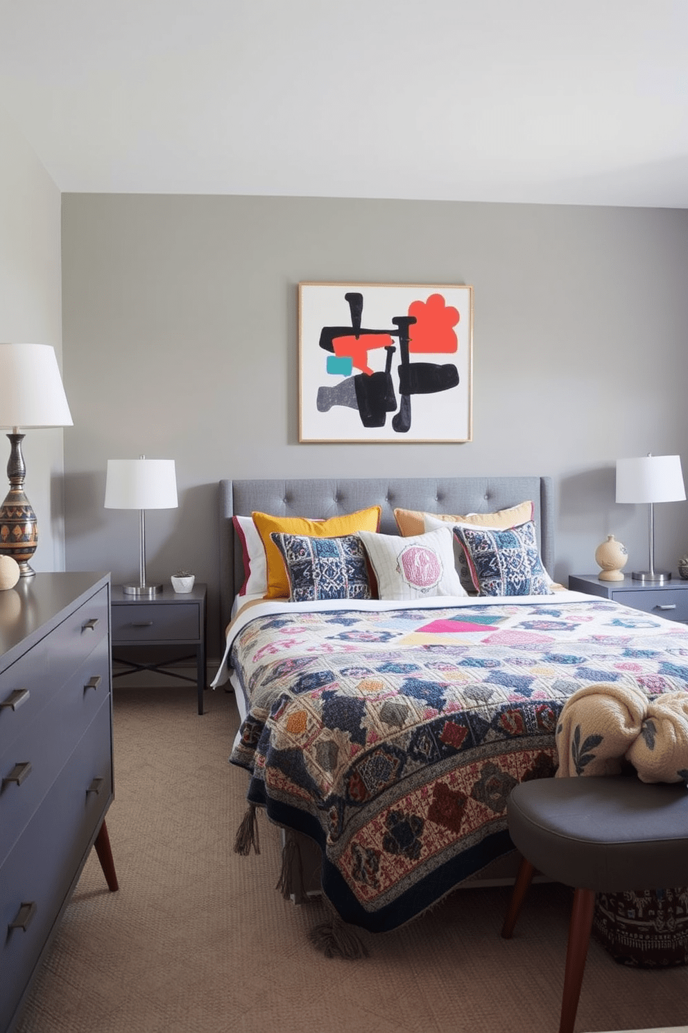 A stylish gray bedroom features mid-century furniture with clean lines and a cozy atmosphere. The bed is adorned with colorful throw pillows and a vibrant quilt, adding a playful touch to the serene gray palette. The room includes a sleek gray dresser and a pair of mid-century nightstands, each topped with unique decorative lamps. A bold piece of abstract art hangs above the bed, creating a focal point that enhances the overall design.