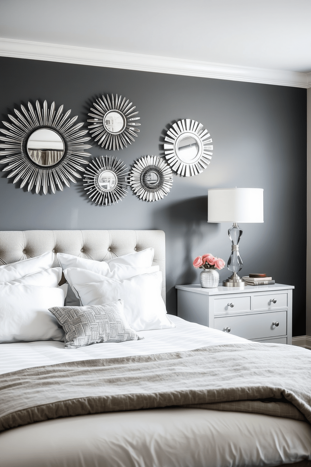 A modern gray bedroom featuring a striking accent wall adorned with mirrored decor pieces that reflect light beautifully. The room is complemented by plush bedding in soft white and silver tones, creating a serene and inviting atmosphere.