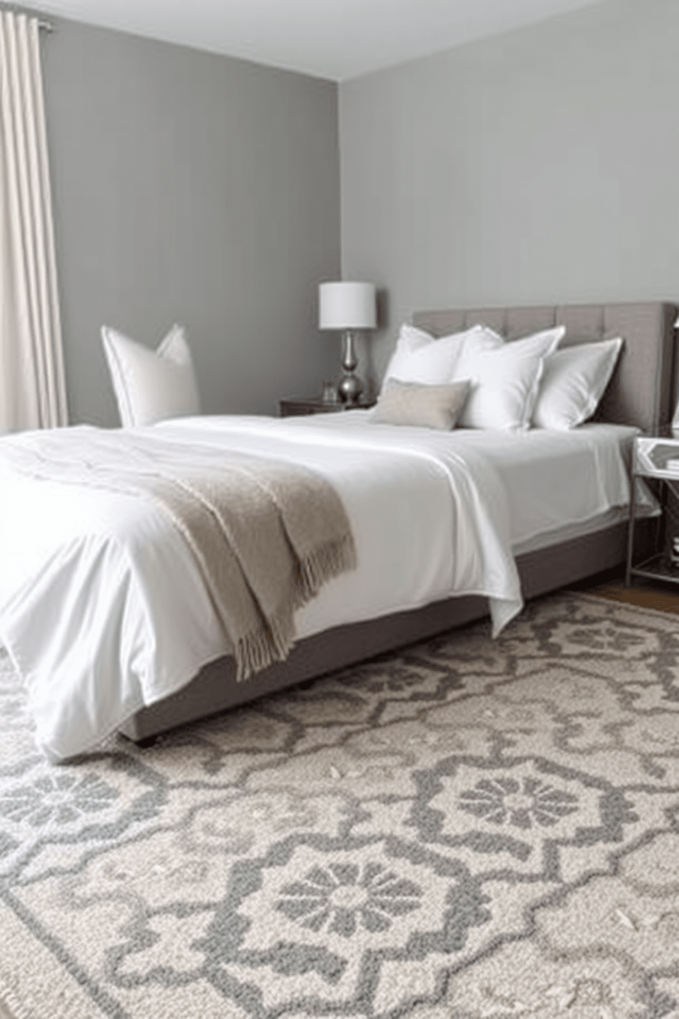 A cozy gray bedroom featuring a geometric patterned rug that adds texture and visual interest to the space. The walls are painted in a soft gray hue, complemented by crisp white bedding and elegant decorative pillows.