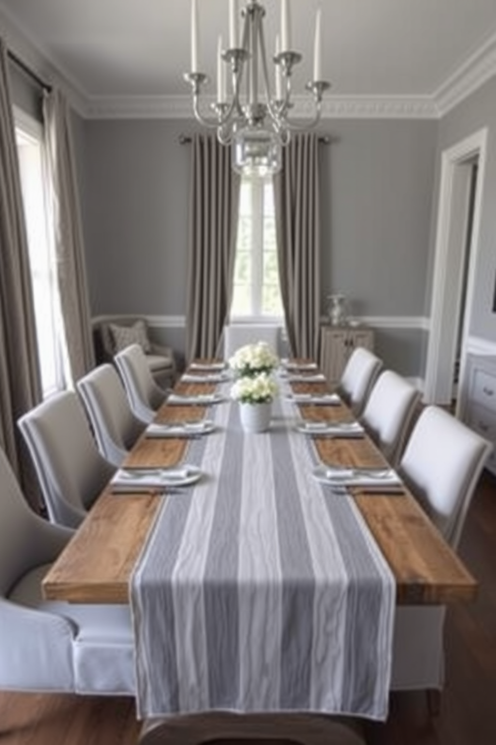 A stylish gray dining room featuring a long wooden table set with a gray and white striped table runner. Surrounding the table are elegant upholstered chairs in a complementary shade, creating a cohesive and inviting atmosphere.