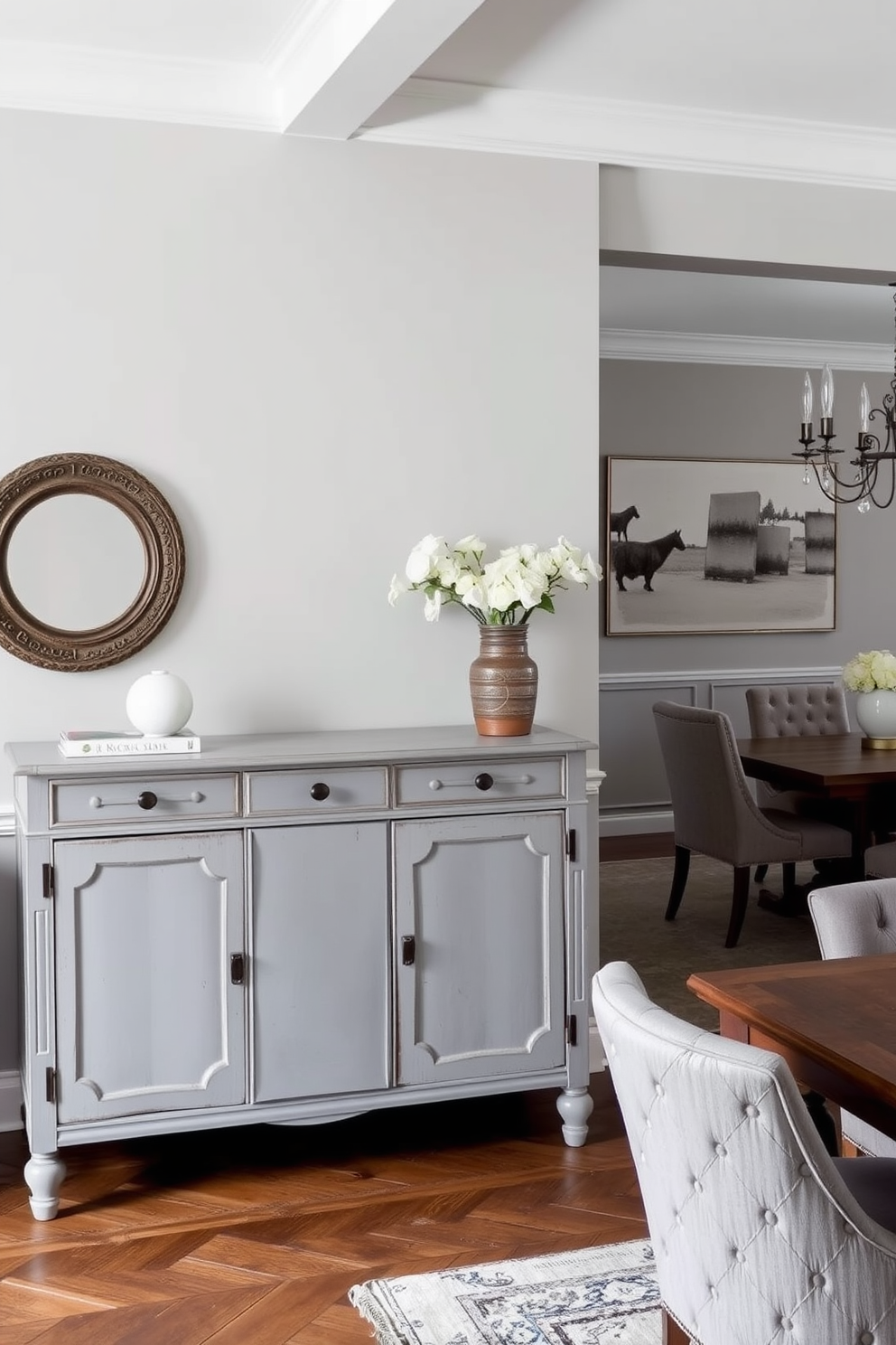 A vintage gray sideboard stands elegantly against the wall, providing ample storage and a touch of character to the space. The dining room features a harmonious blend of gray tones, with a large wooden dining table surrounded by upholstered chairs in complementary shades.