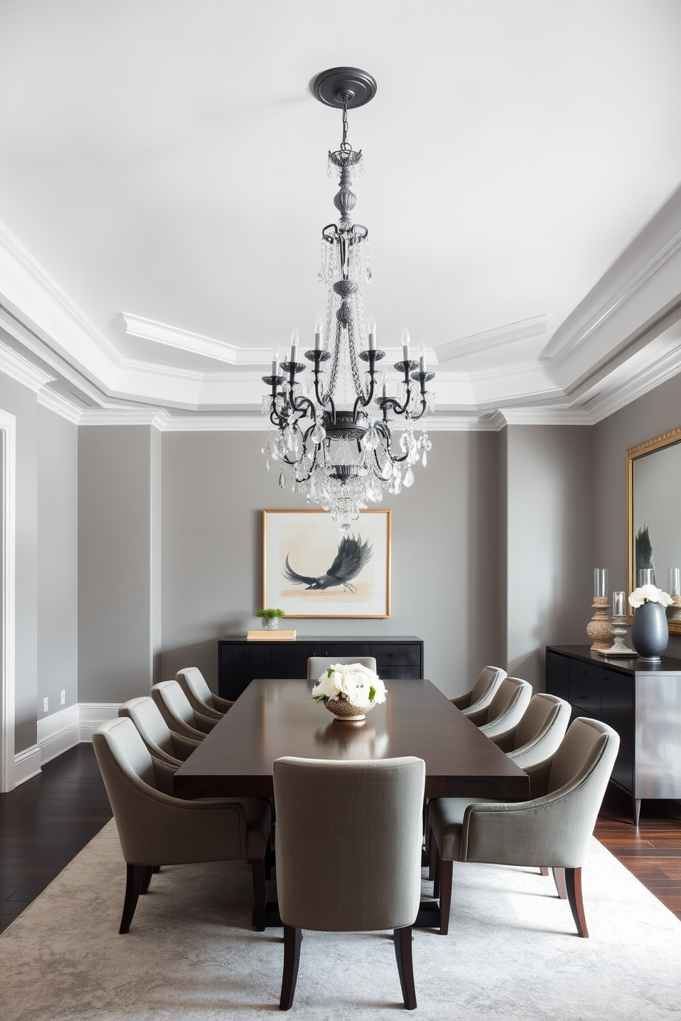 An elegant gray chandelier hangs gracefully from the ceiling, serving as the stunning focal point of the dining room. The walls are painted in a soft gray shade, creating a sophisticated backdrop for the space. A large rectangular dining table is centered beneath the chandelier, surrounded by plush upholstered chairs in a complementary tone. A sleek sideboard against one wall displays decorative items and adds functionality to the room.