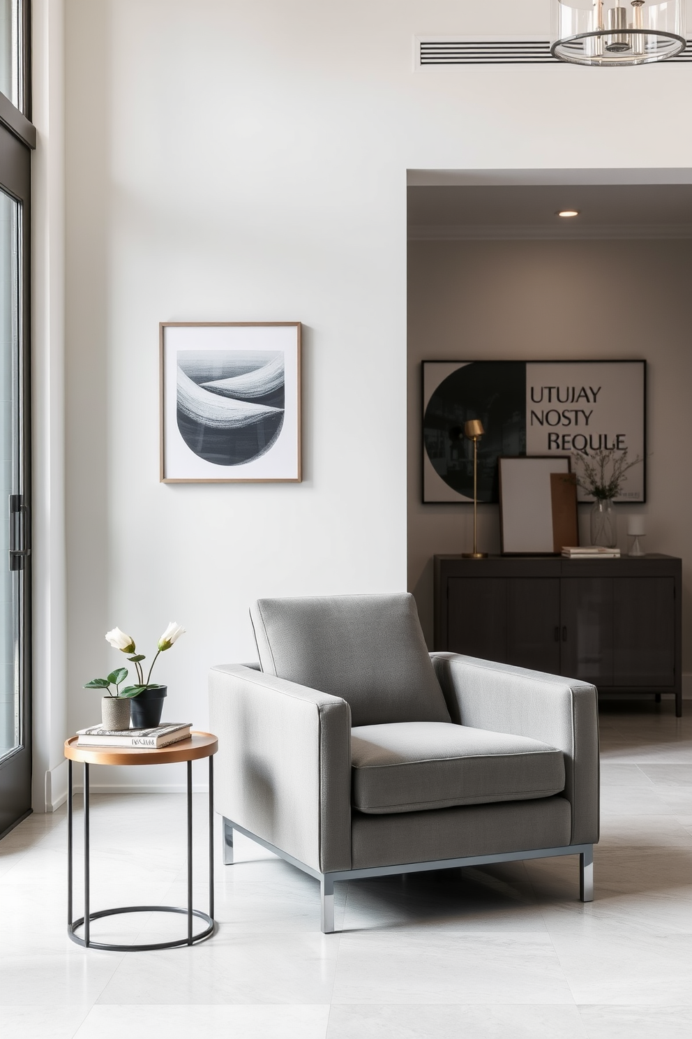 A contemporary gray armchair is positioned in a stylish seating area, featuring sleek lines and plush upholstery that invites relaxation. The chair is complemented by a minimalist side table, adorned with a small potted plant and a decorative book. The foyer showcases a sophisticated gray design, with a statement console table against the wall that highlights modern art pieces. Soft lighting illuminates the space, creating a warm and welcoming atmosphere while enhancing the elegant gray tones throughout.