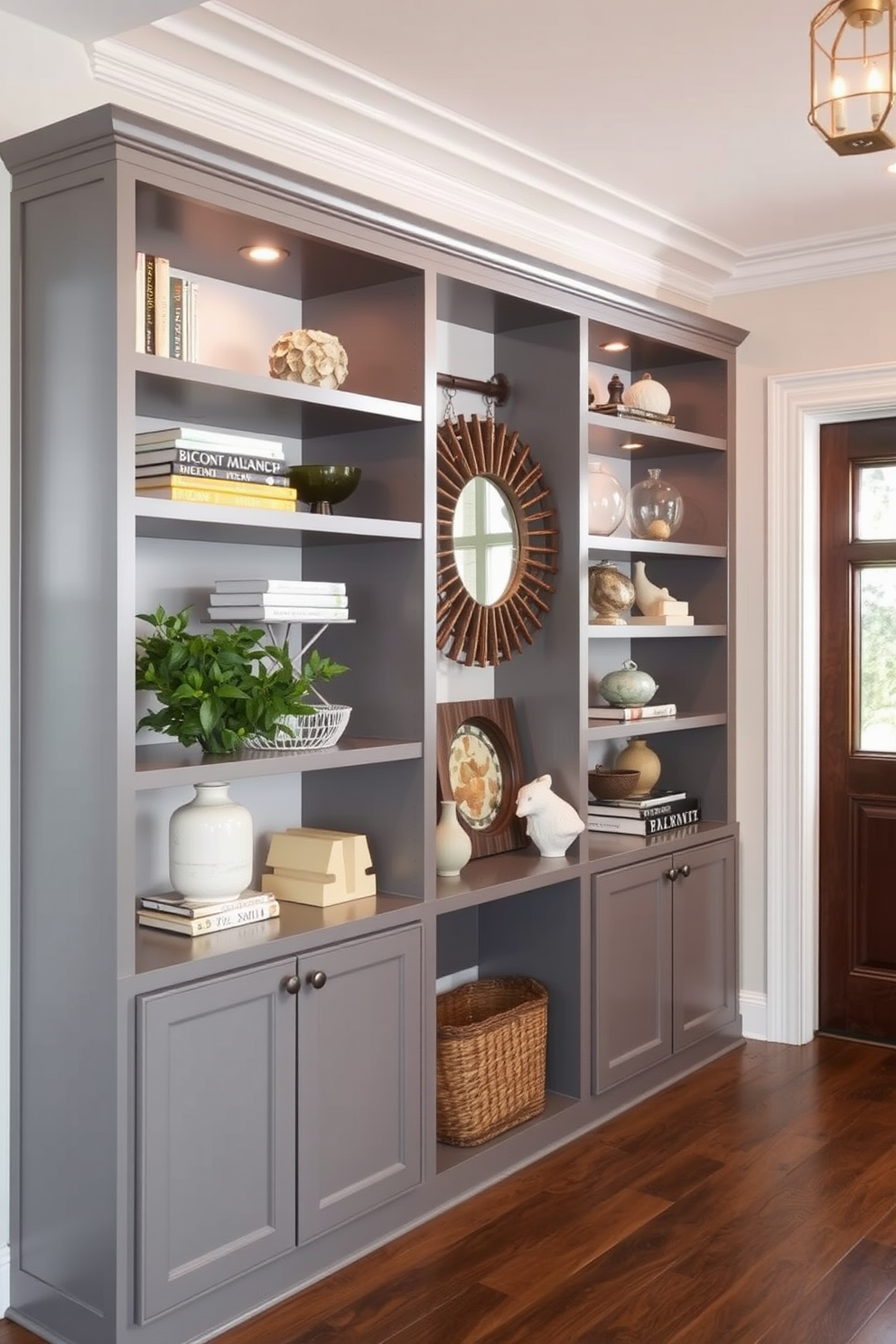 A stylish foyer featuring open shelving in a sleek gray finish. The shelves are adorned with decorative items and books, creating an inviting and organized space.