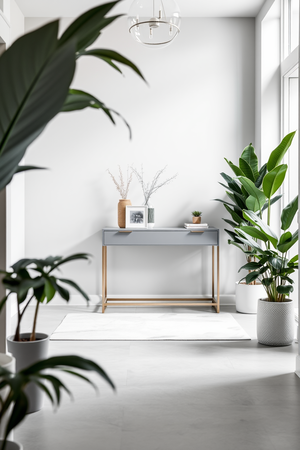 A stylish foyer featuring a soft gray color palette with elegant green plants strategically placed throughout the space. The floor is adorned with a light gray rug, and a sleek console table sits against the wall, topped with decorative items and a small potted plant.