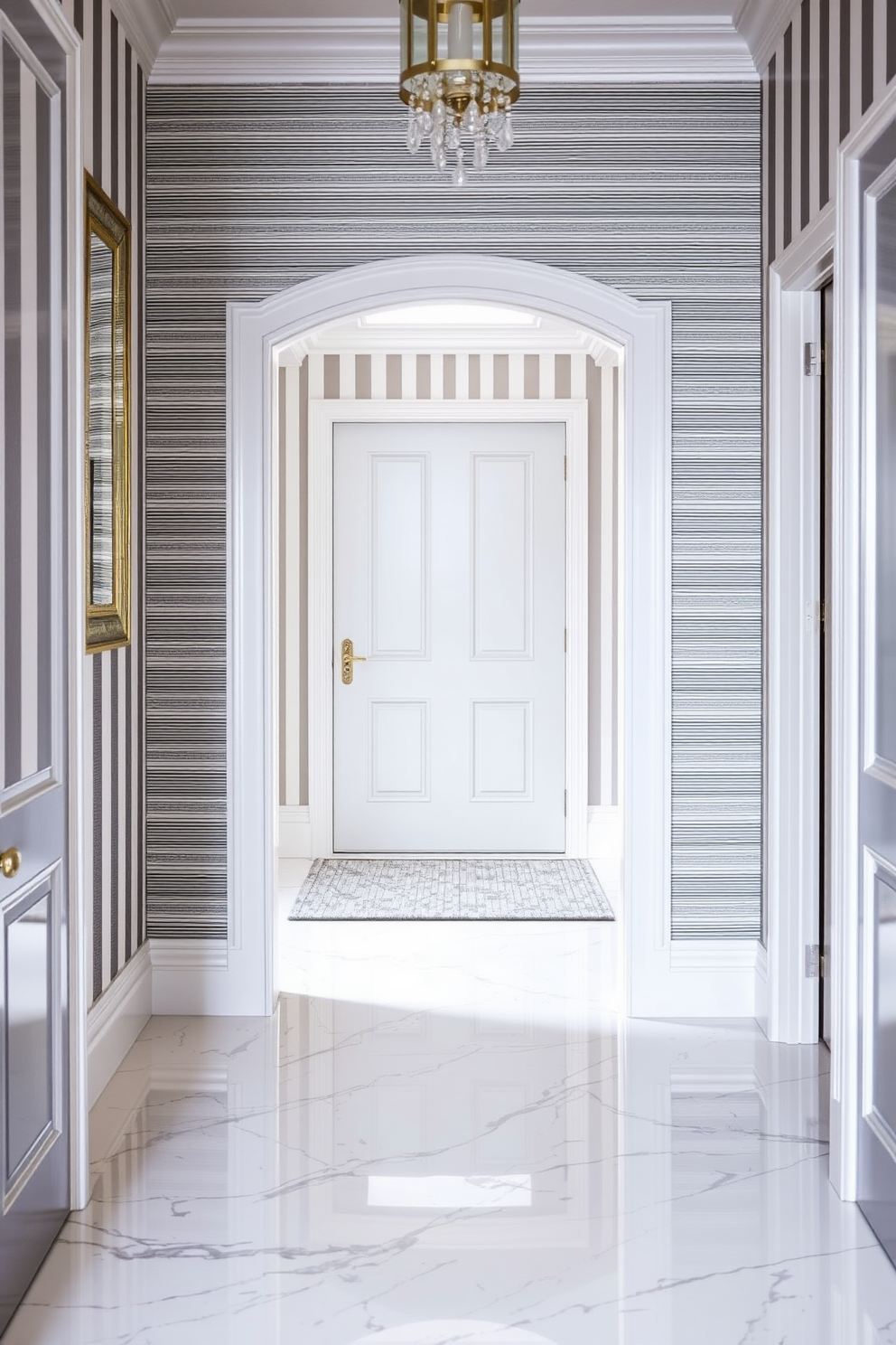 A chic foyer features gray and white striped wallpaper that adds a touch of elegance to the space. The floor is adorned with a sleek white marble that complements the wallpaper, creating a harmonious and inviting atmosphere.