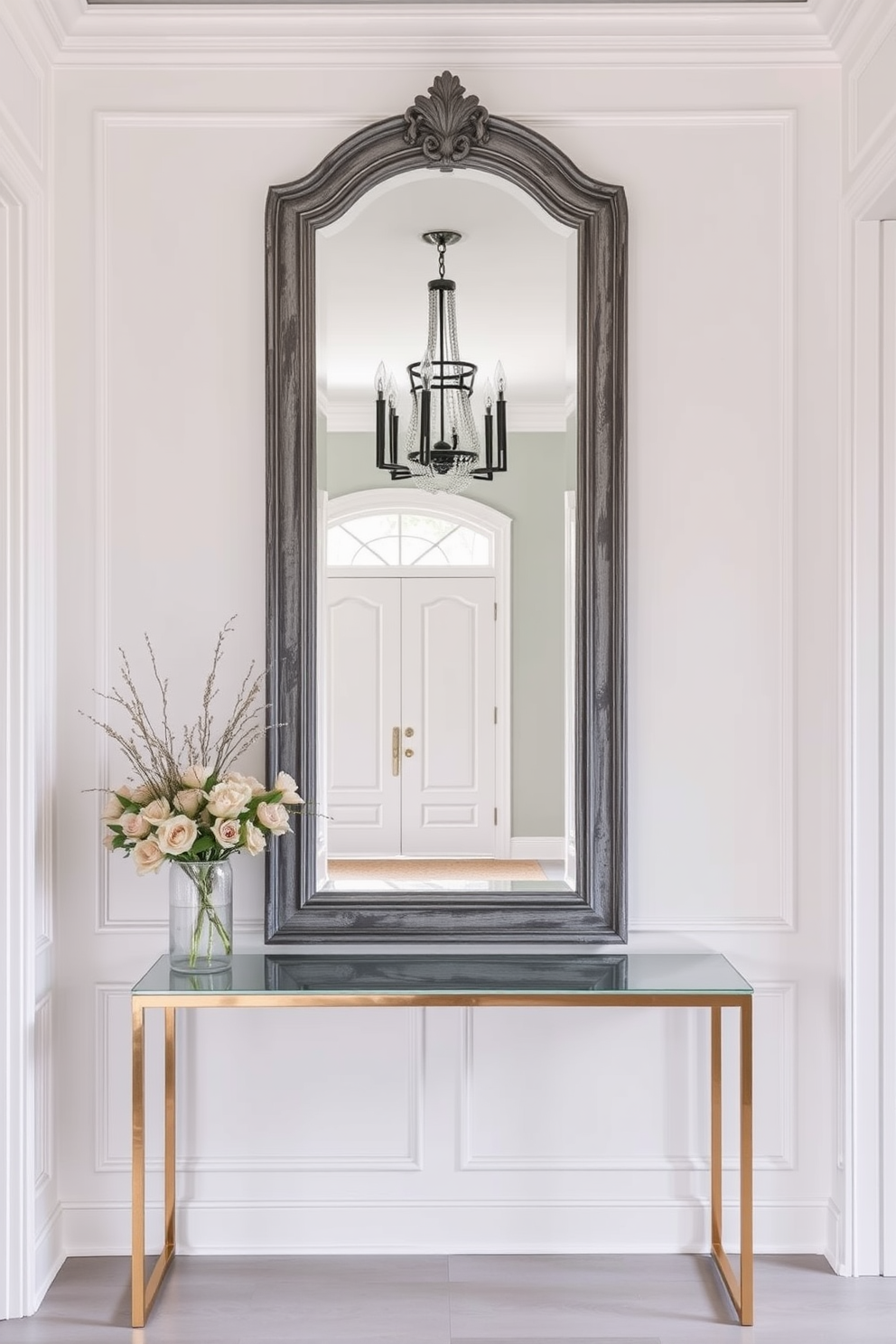 A stunning foyer featuring a statement mirror framed in distressed gray. The walls are adorned with soft white paneling, complemented by a sleek console table beneath the mirror.