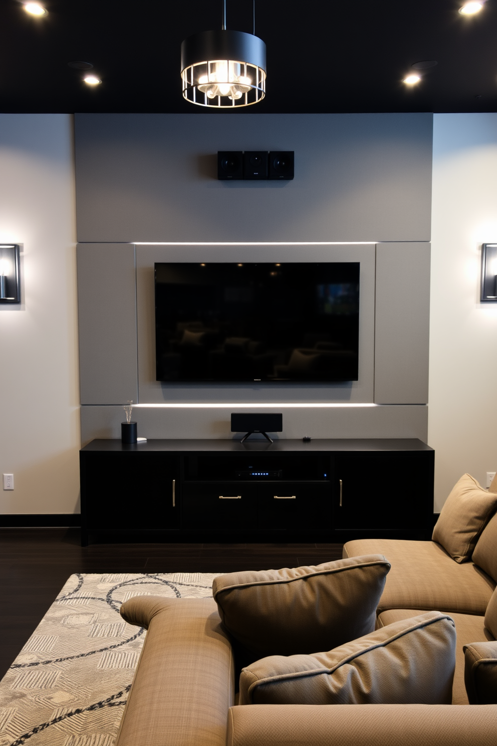 A modern game room featuring a gray wall-mounted TV seamlessly integrated with a high-quality sound system. The space is designed with comfortable seating options, including a plush sectional sofa, and accentuated by stylish lighting fixtures that create an inviting atmosphere.